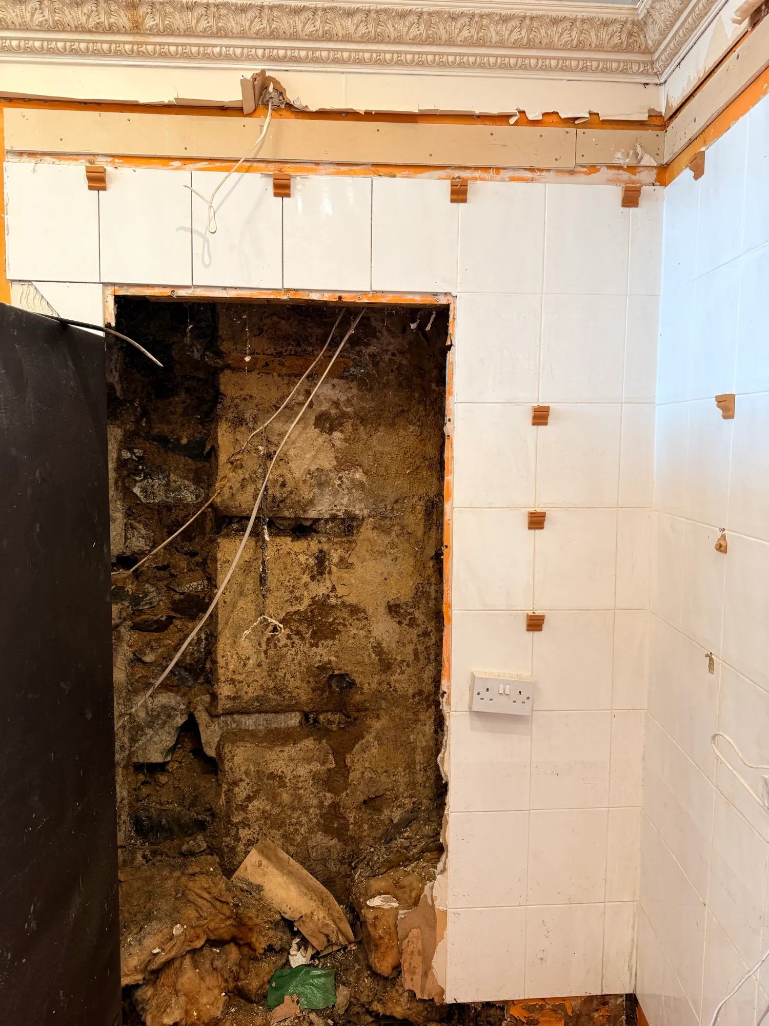 The big hole in the stud wall shows the complete lack of insulation or damp proofing betwe — photo 1 of 2.