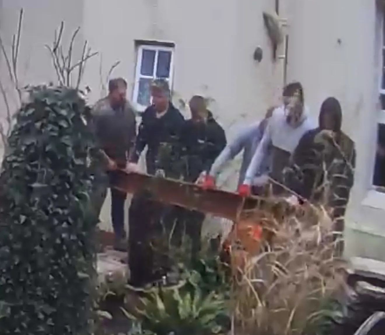 Oh look, it’s an entire five-a-side team (with a sub) carrying steel into the house.