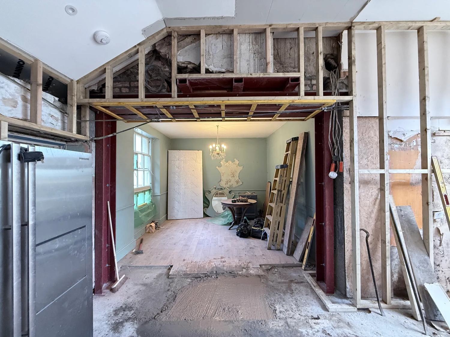 The hole in the house is now supporting itself and the framing is starting to go up around — photo 1 of 3.