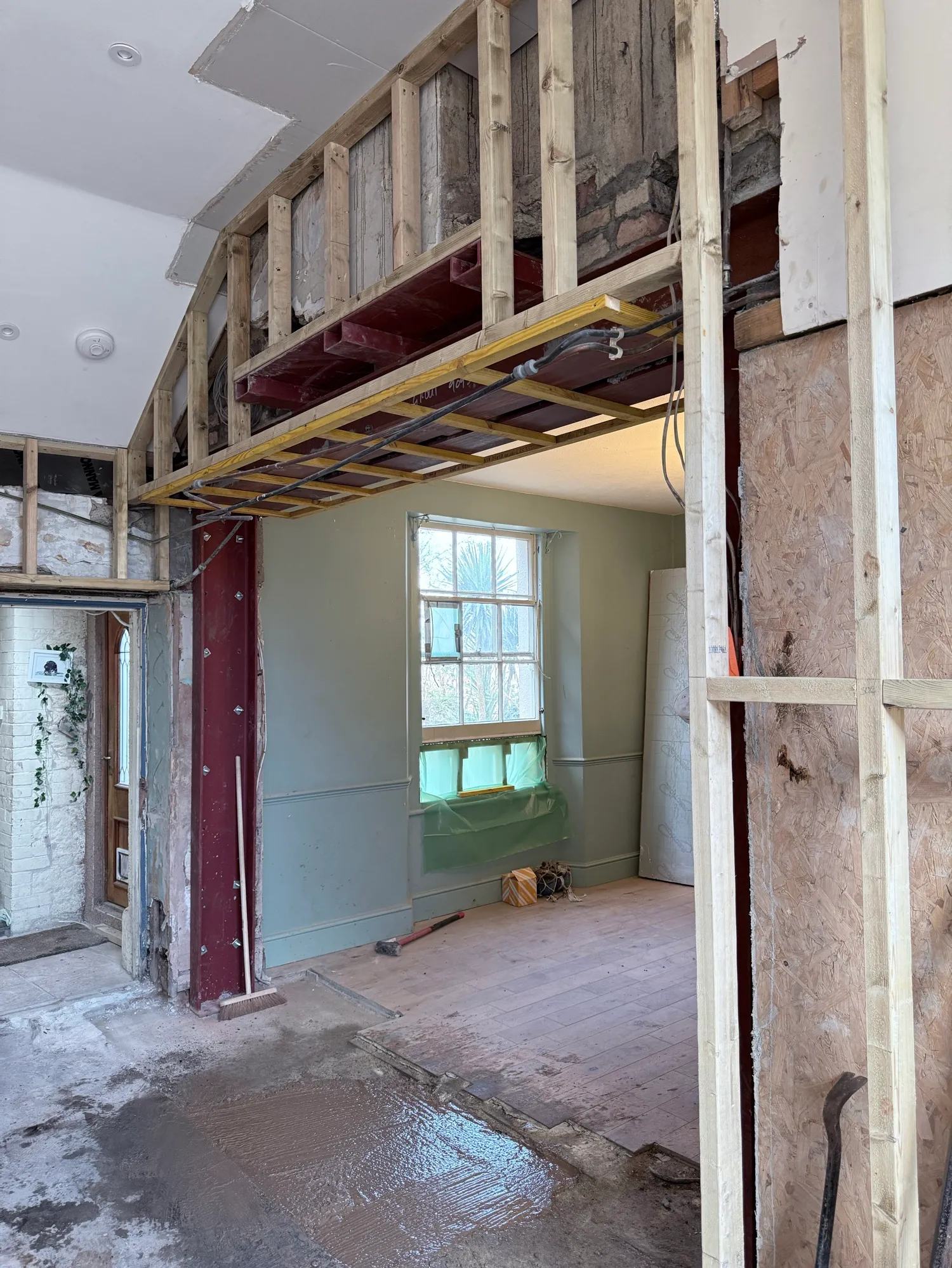 The hole in the house is now supporting itself and the framing is starting to go up around — photo 2 of 3.