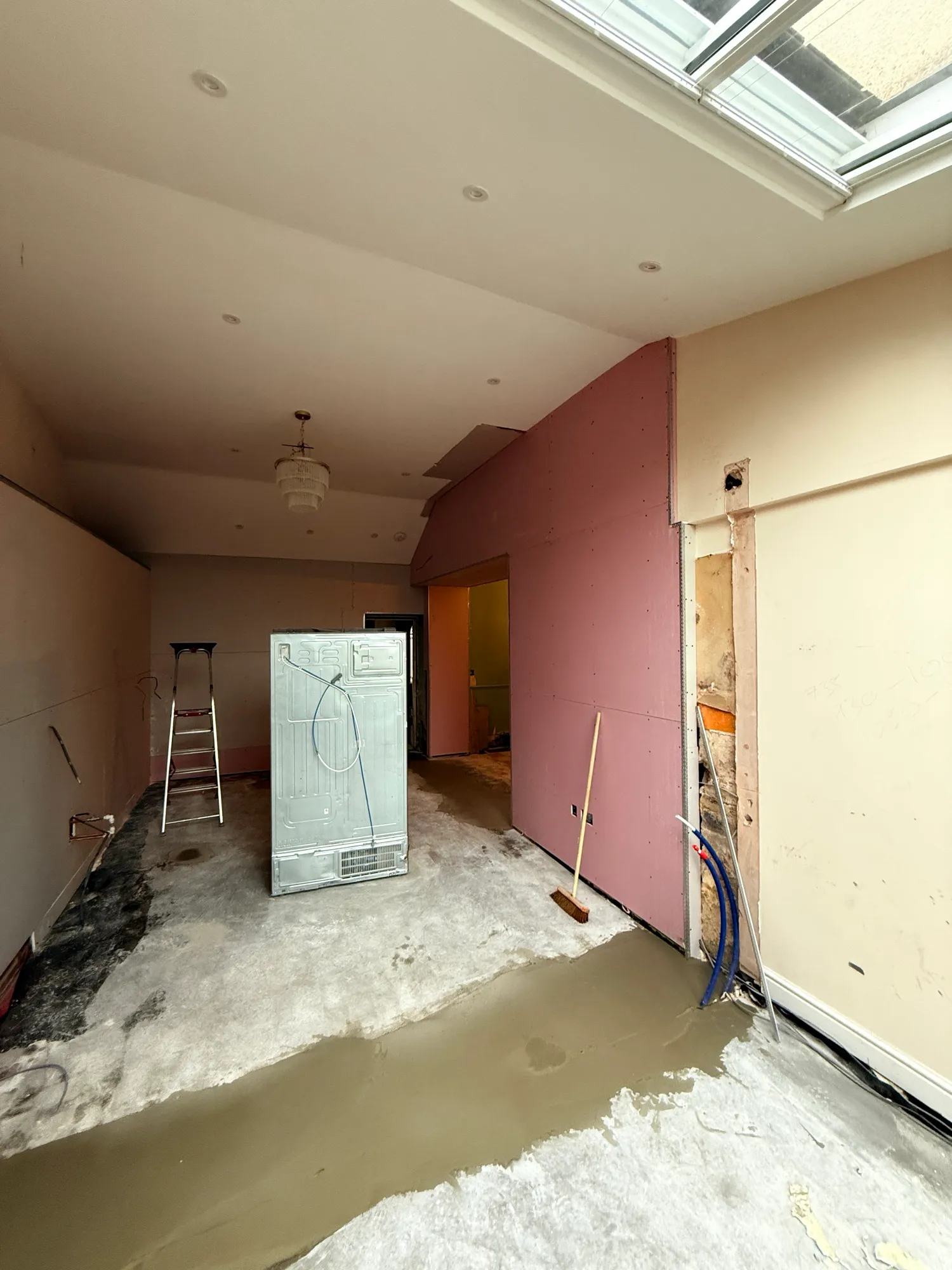 Looking in to the kitchen from the conservatory end with some setting concrete and plasterboard.