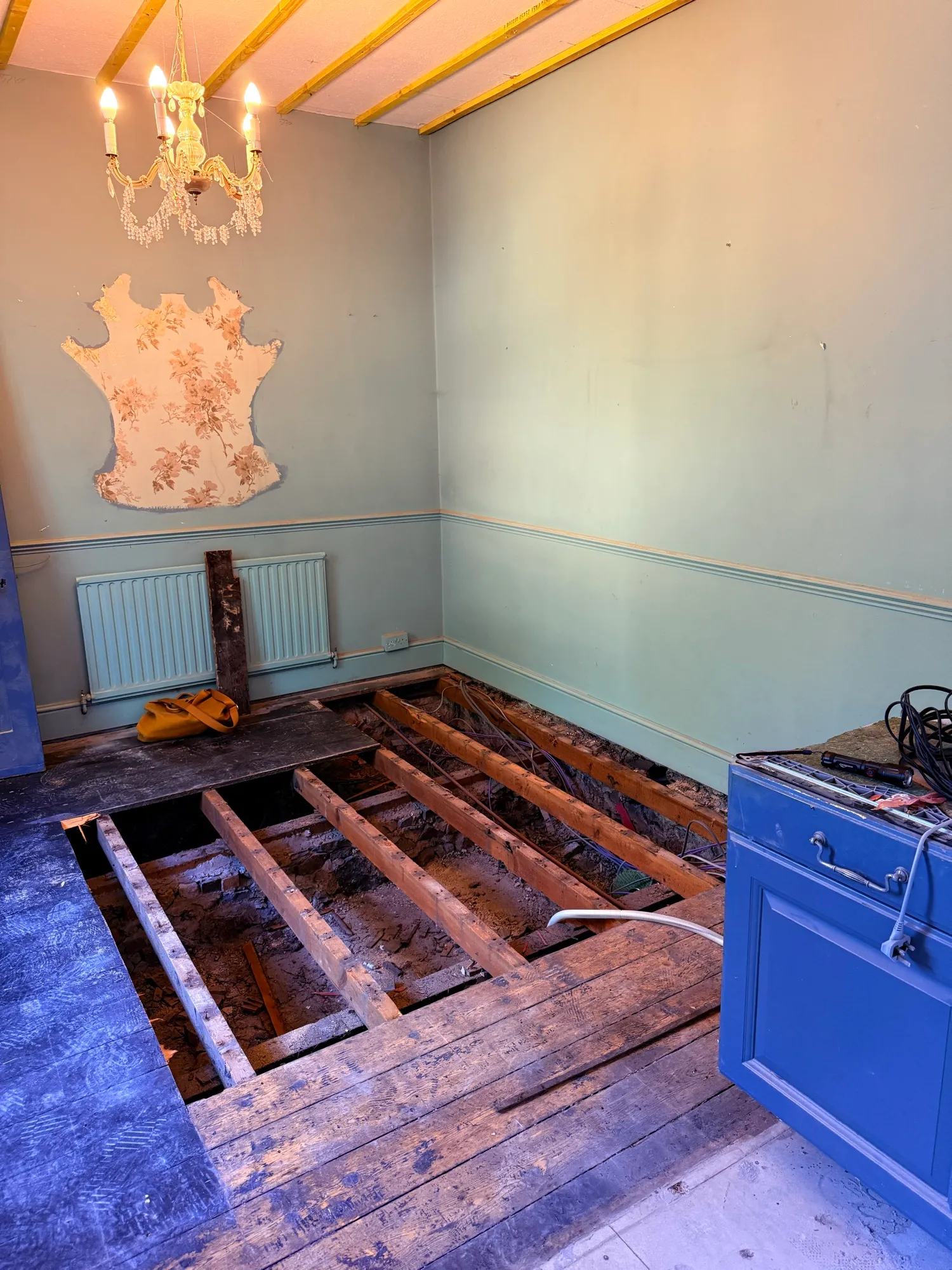 Suspended floor with a bunch of boards removed to allow services to be run. Sadly there appears to be a total of zero precious artefacts hidden in the void with which to pay for the kitchen.
