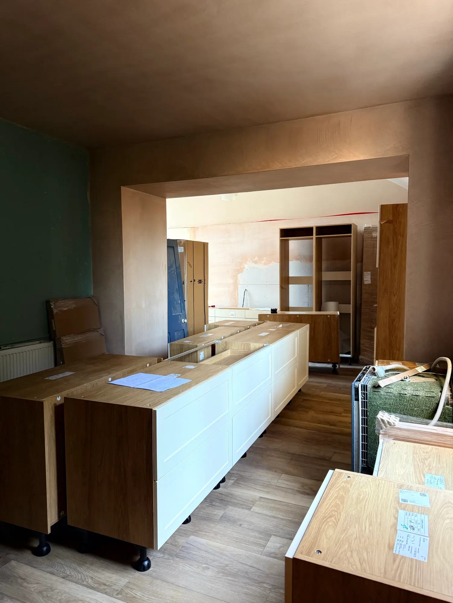 Looking from the hallway across the kitchen island and beyond.