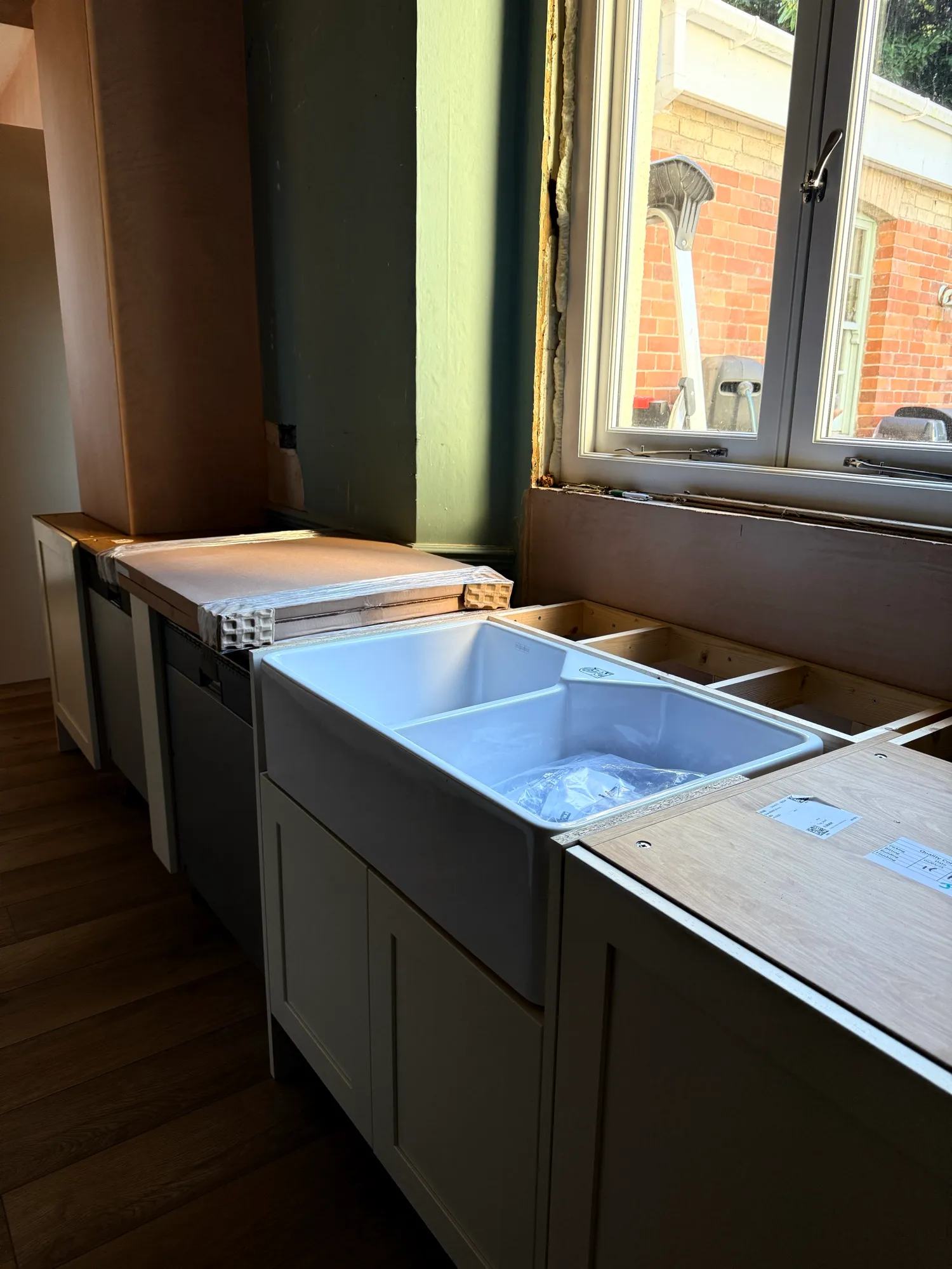 The sink is getting fitted, the back side of the island is now all sorted and the pantry d — photo 1 of 3.