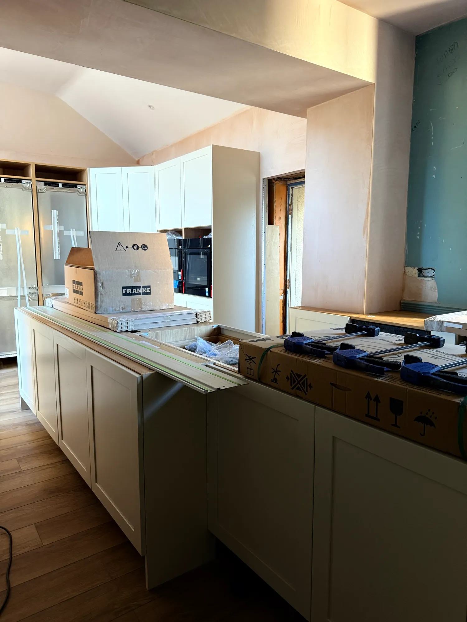 The sink is getting fitted, the back side of the island is now all sorted and the pantry d — photo 2 of 3.