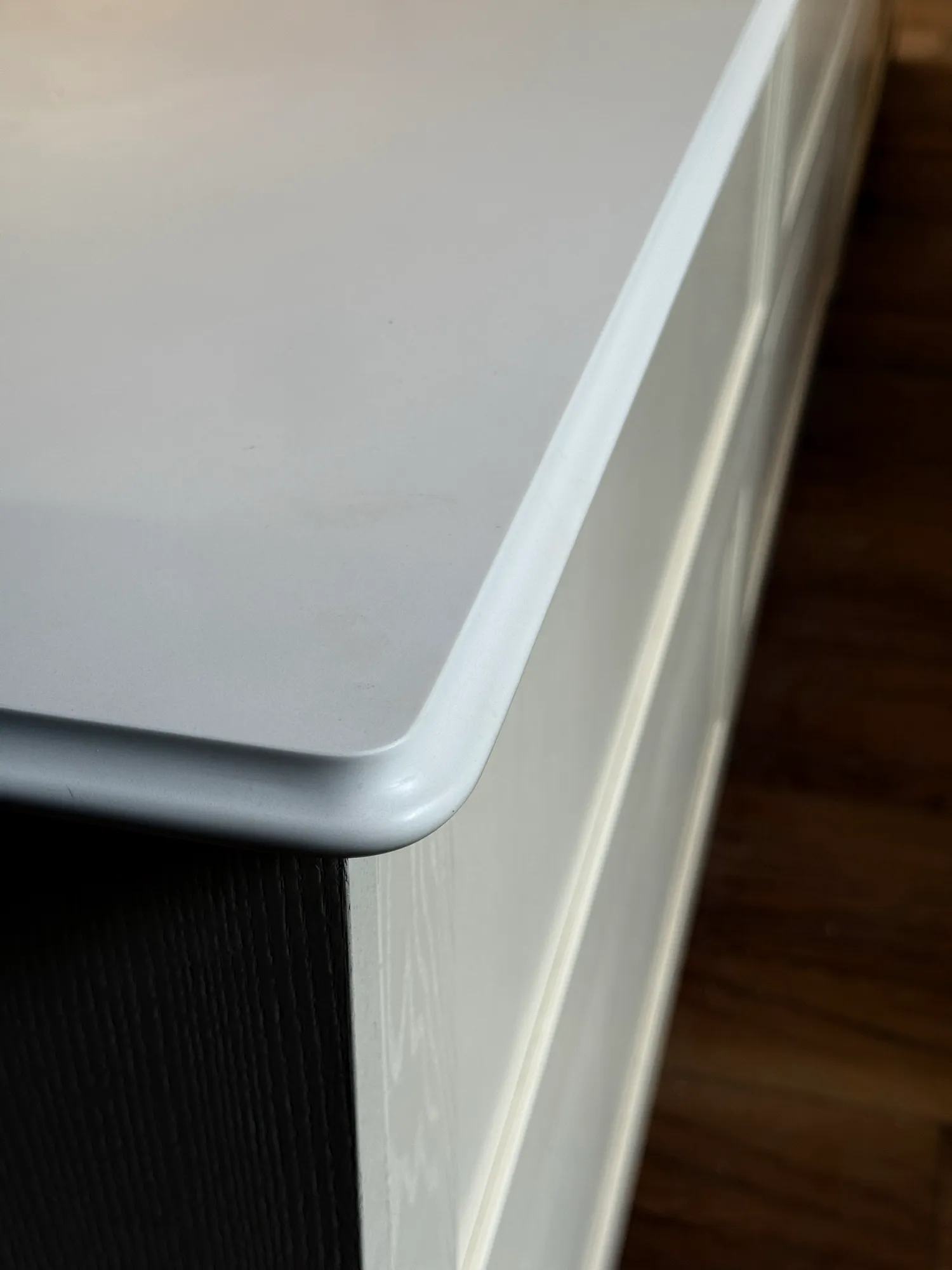 The lambs tongue profile and radius overhanging the corner of the kitchen island.